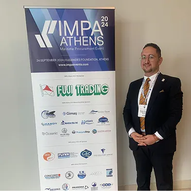 Golden Ocean representative beside an IMPA event banner
